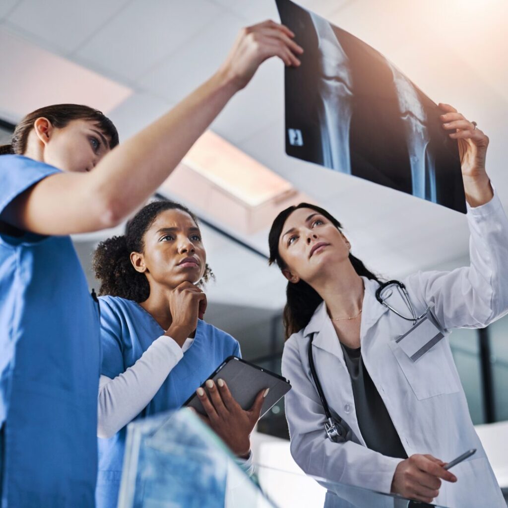 Radiologists looking at an x-ray for a blog on Top 4 States with Radiologist Employment Opportunities in 2025