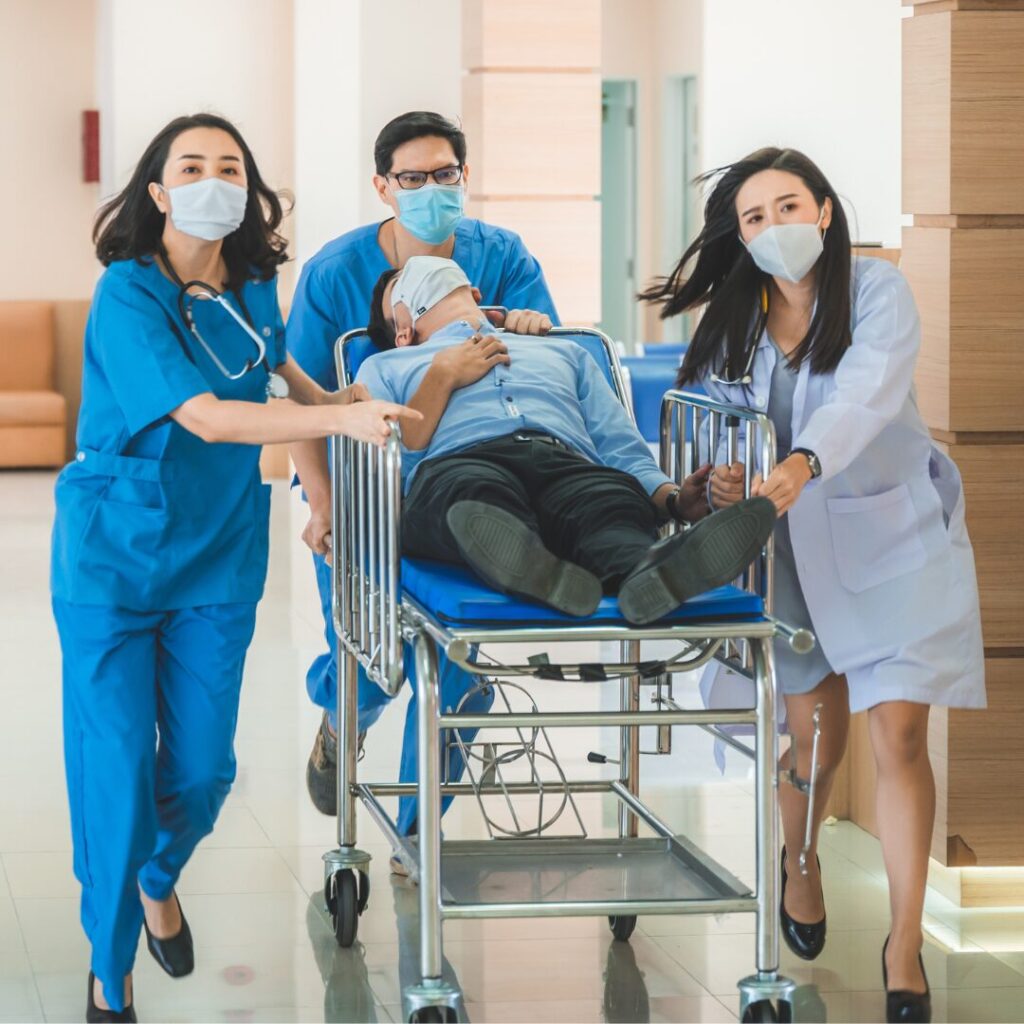 Emergency medicine physicians helping a patient